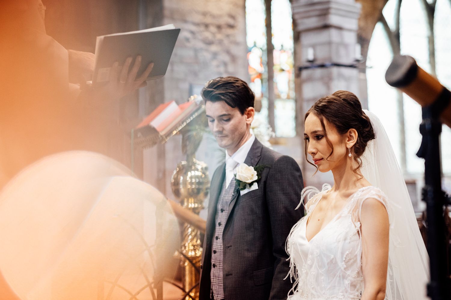 Wedding celebration captured in warm orange tones with elegant decor and lighting.