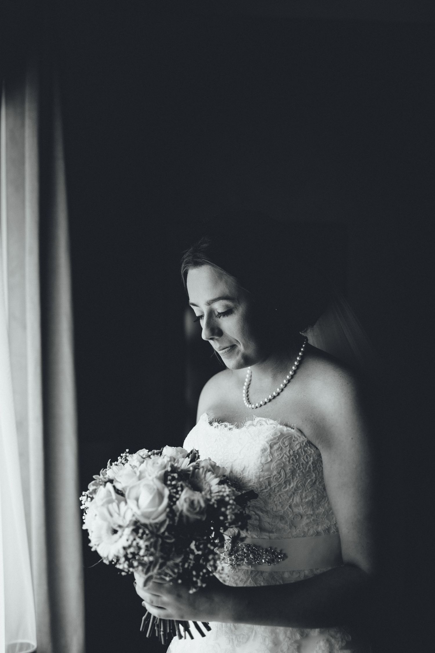 Artistic black and white bridal portraits showing wedding dress and bouquet details.