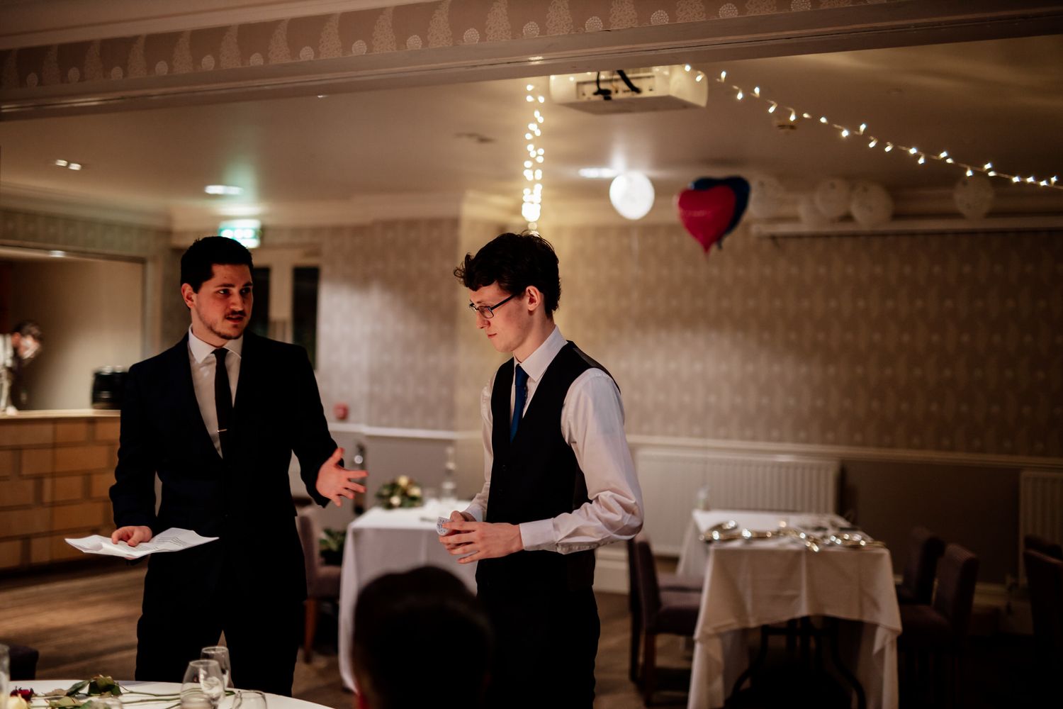 Reception venue with twinkling lights and classic crown molding details.