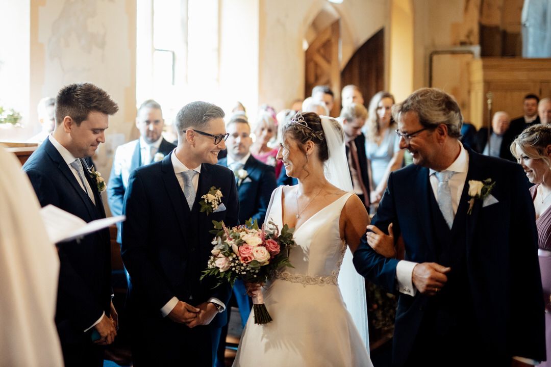 Couple exchanging vows during an intimate church wedding ceremony.