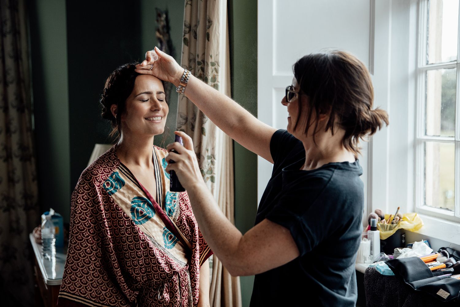 Getting ready scene by a window with natural light streaming in.