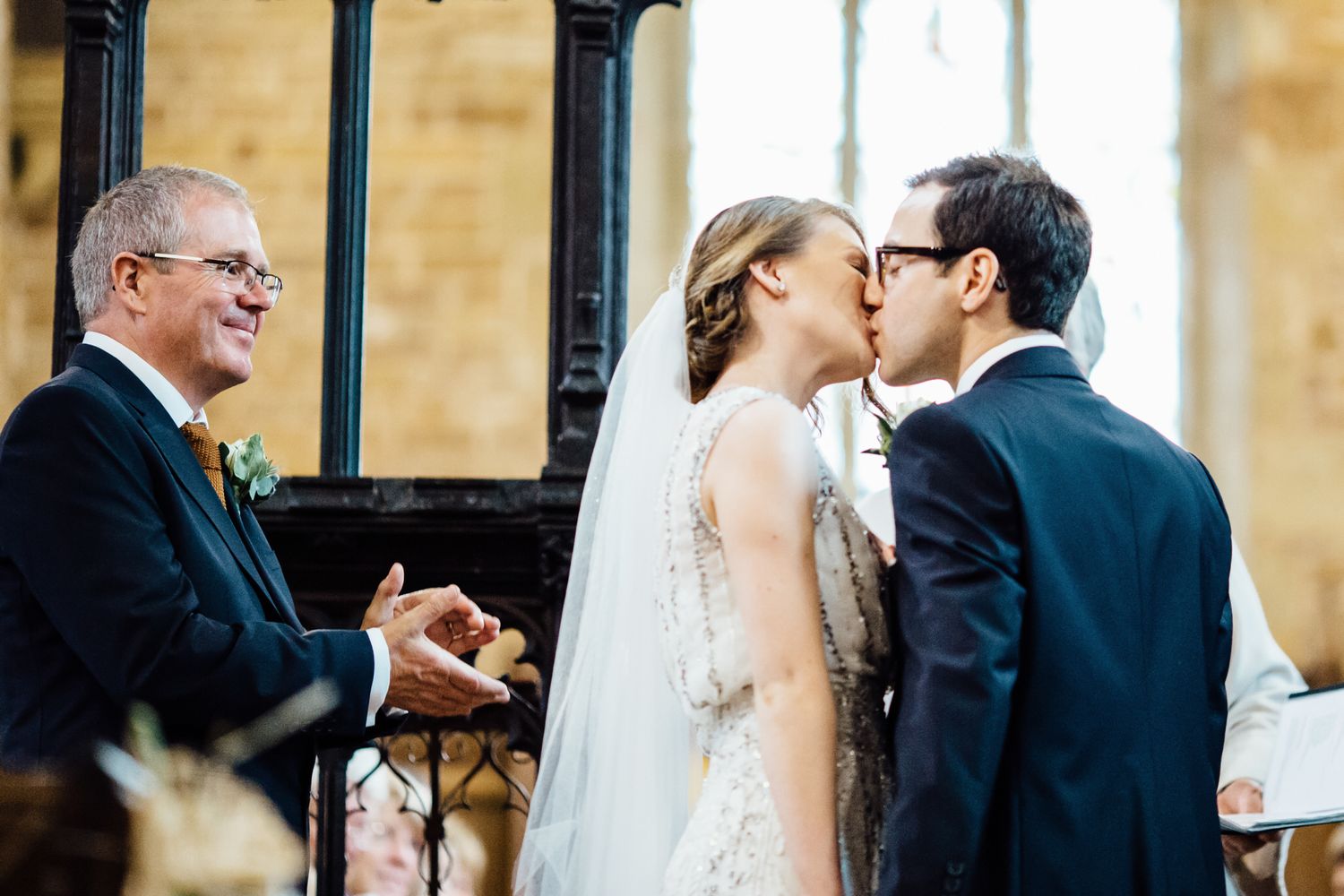Intimate moment captured between couple during wedding ceremony in church setting.