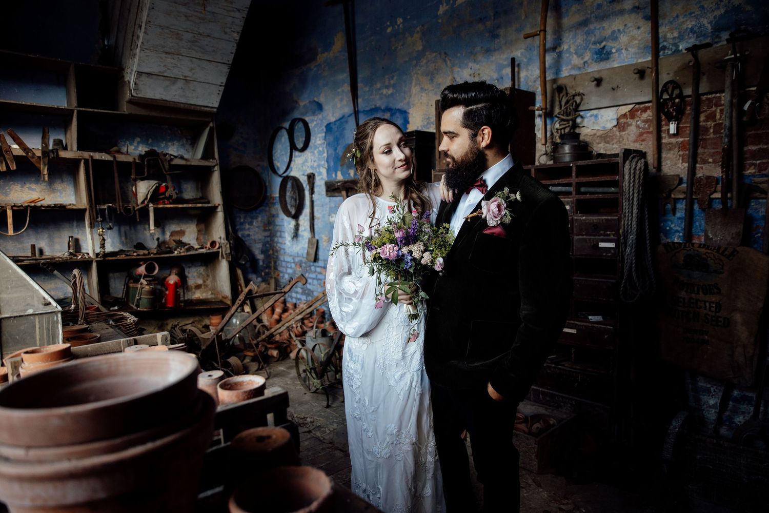 Artistic wedding photography in moody industrial space with dramatic lighting. Calke Abbey Wedding Photography