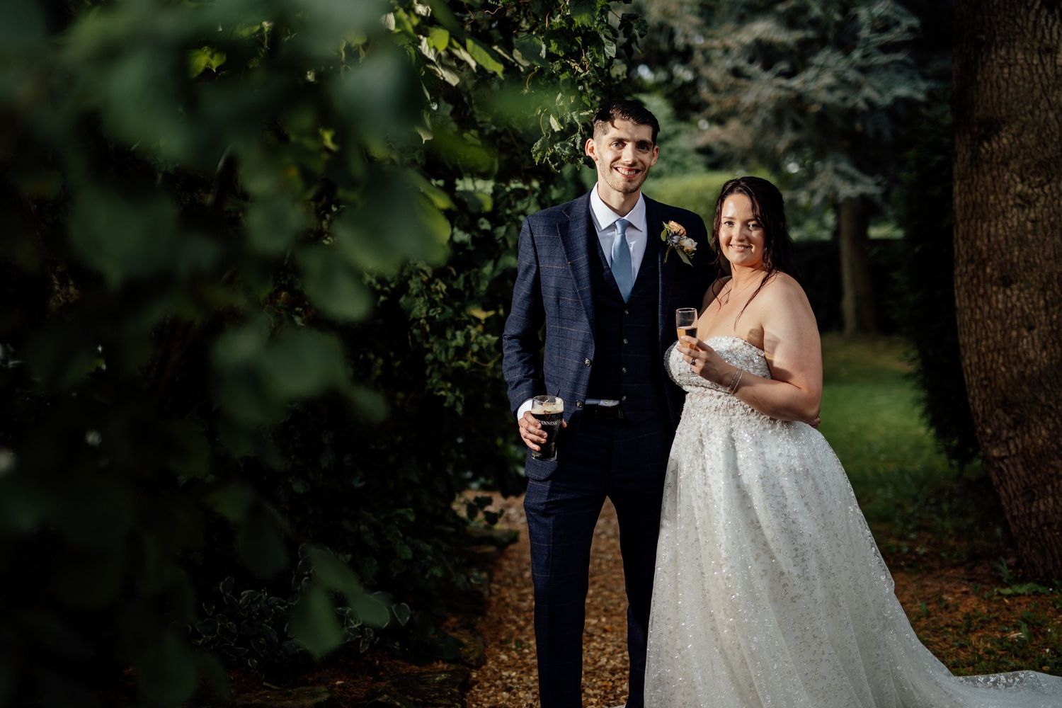 Romantic wedding portrait in a lush garden setting.