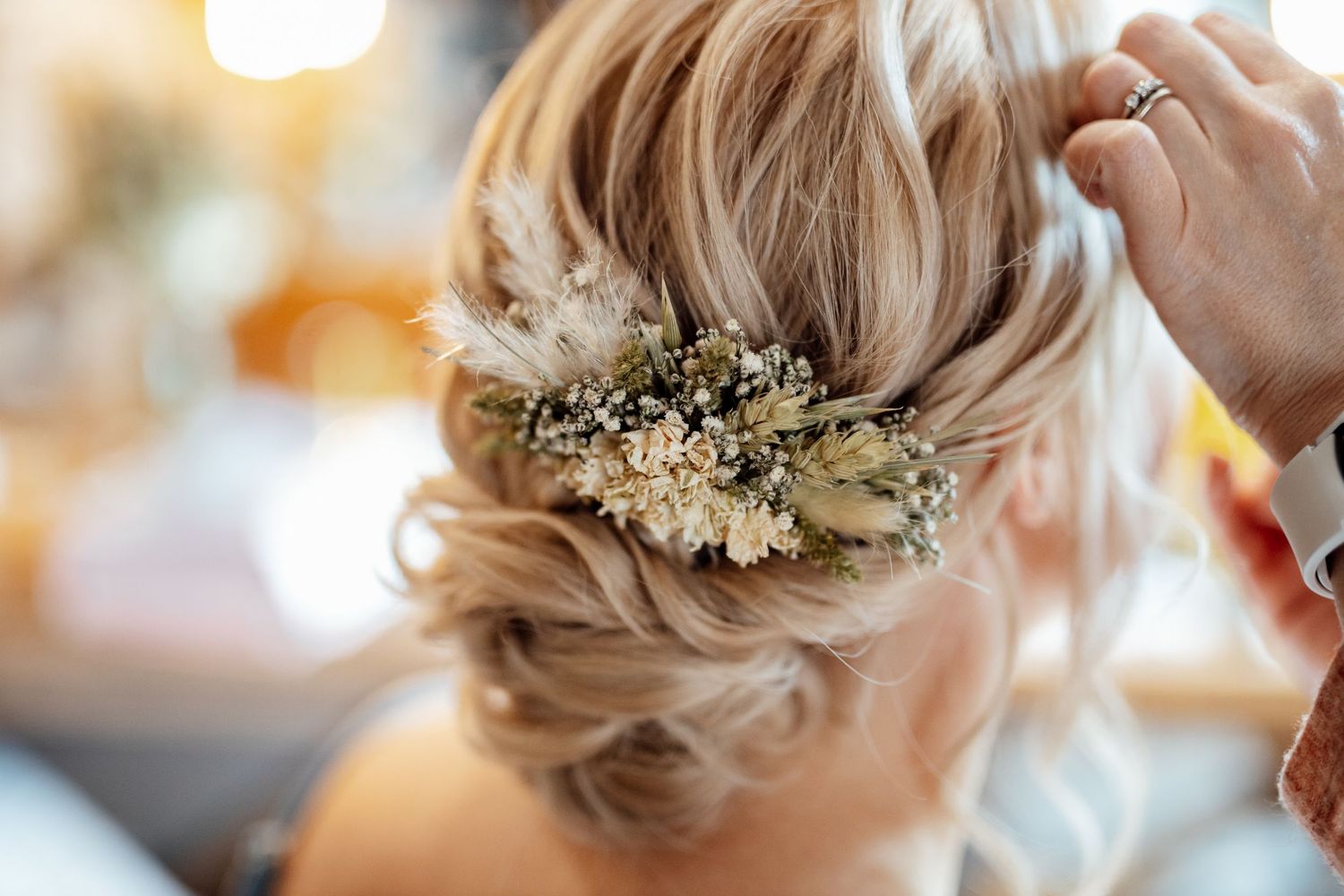 Elegant bridal hair styling with delicate floral accessories.