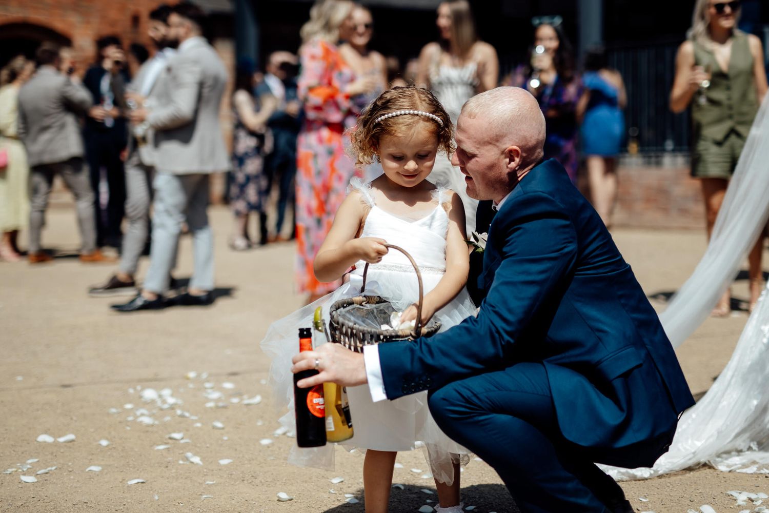 Wedding celebration with guests dancing and enjoying festivities in outdoor setting.
