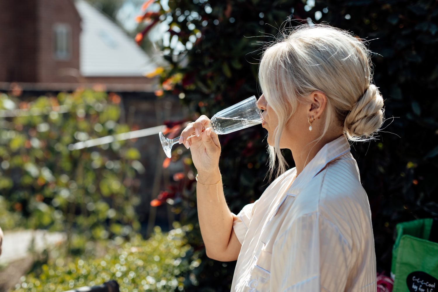 Guests enjoy drinks and celebrate at an outdoor garden party reception.