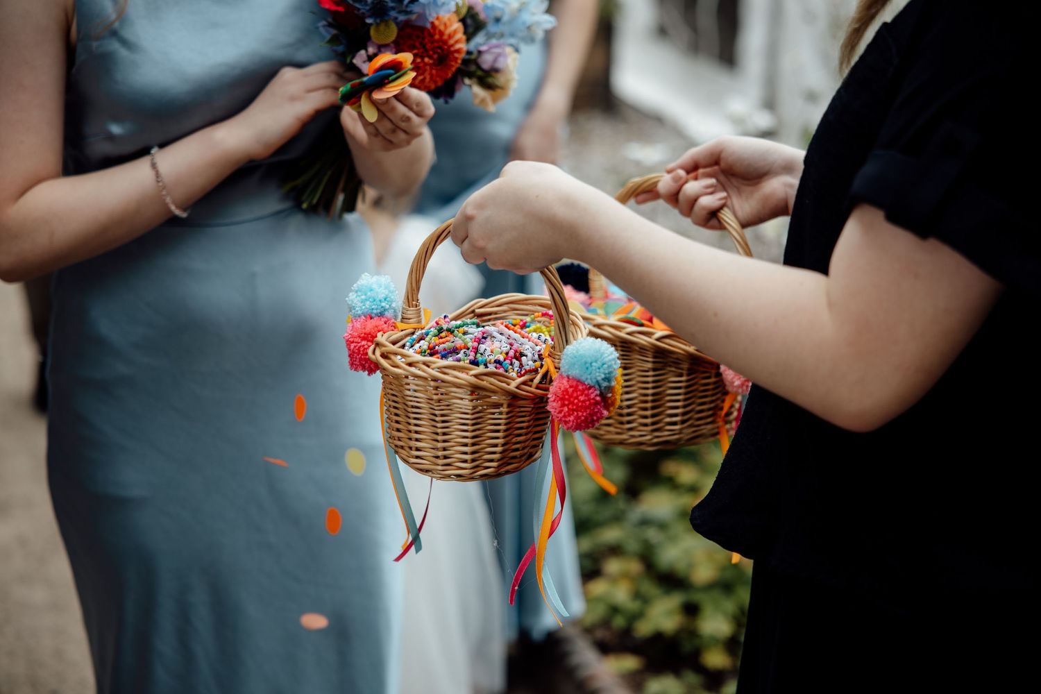 Wedding party members in blue dresses hold flower bouquets during celebrations.