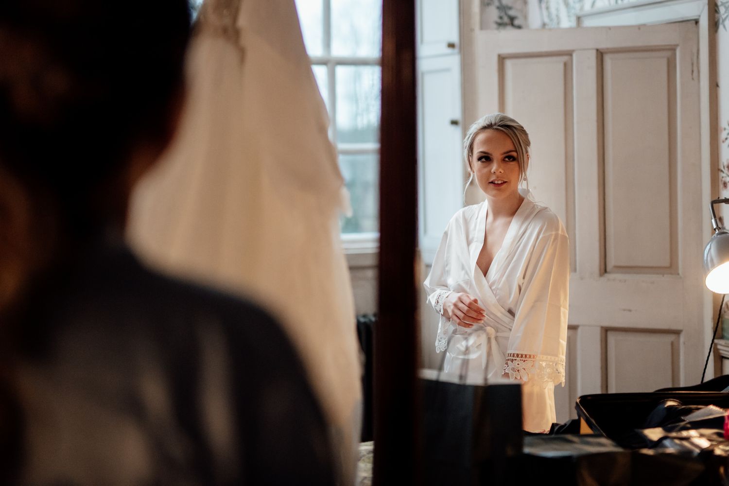 Morning wedding preparations in a bright sunlit room with elegant decor.