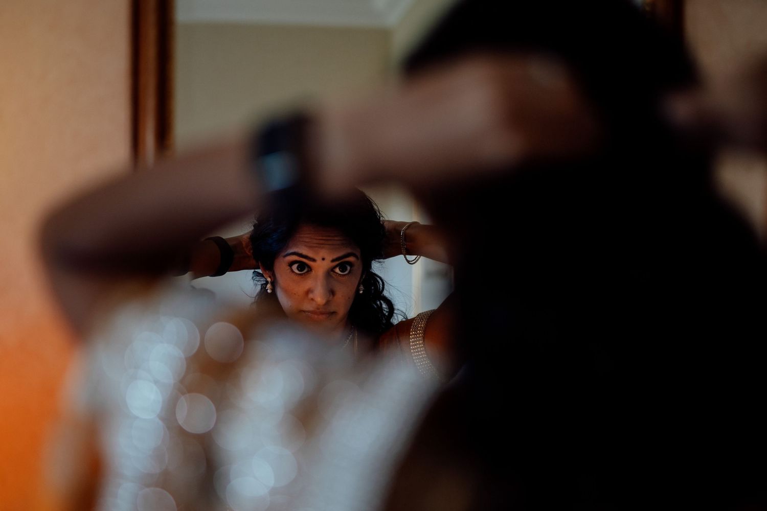 Getting ready scene with soft lighting and mirror reflections.
