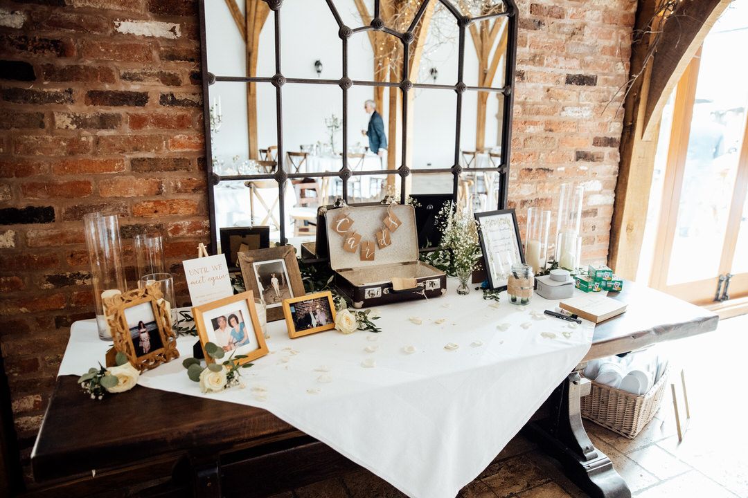 Rustic wedding reception venue with exposed brick walls and wooden beams.