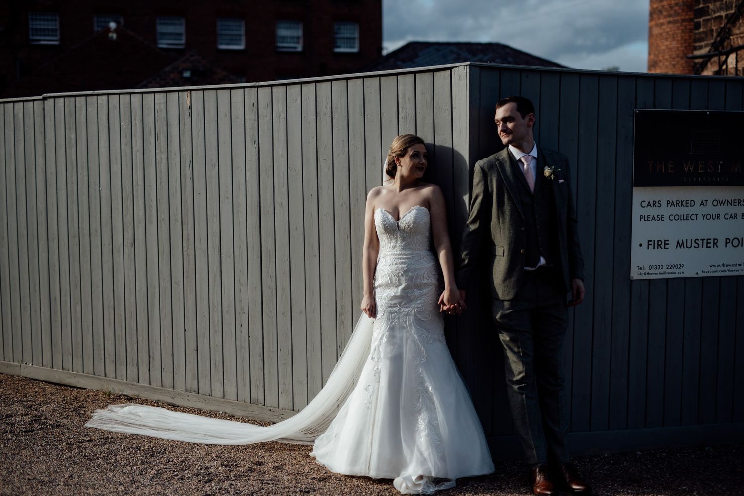 Exterior view of an industrial-style wedding venue with corrugated metal walls.