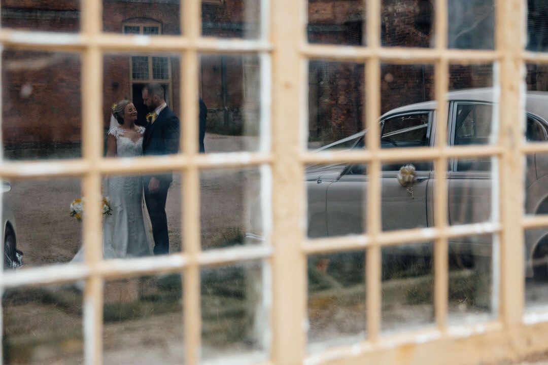 Rustic window panes create geometric pattern in wedding venue setting.