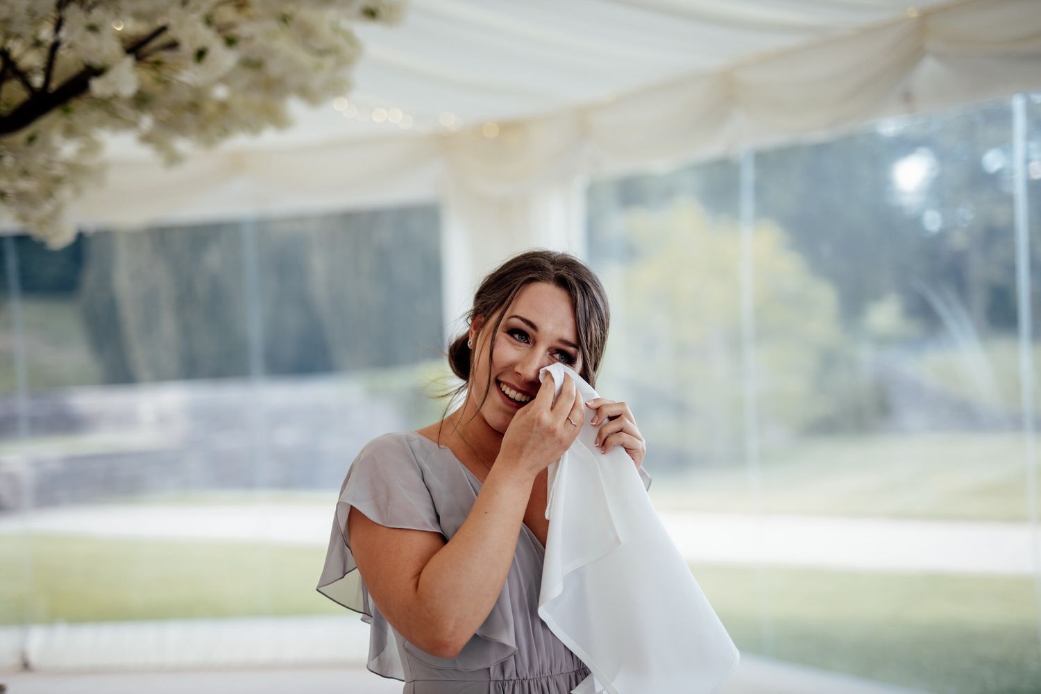 Elegant wedding party preparations in a sun-drenched outdoor setting with flowing dresses and natural lighting.