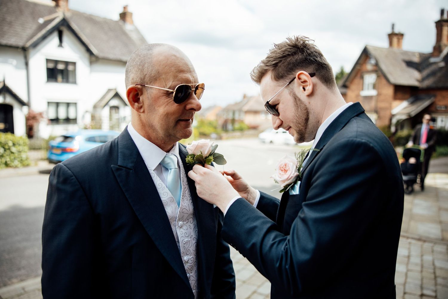 Candid moments between wedding party members in formal attire outside.