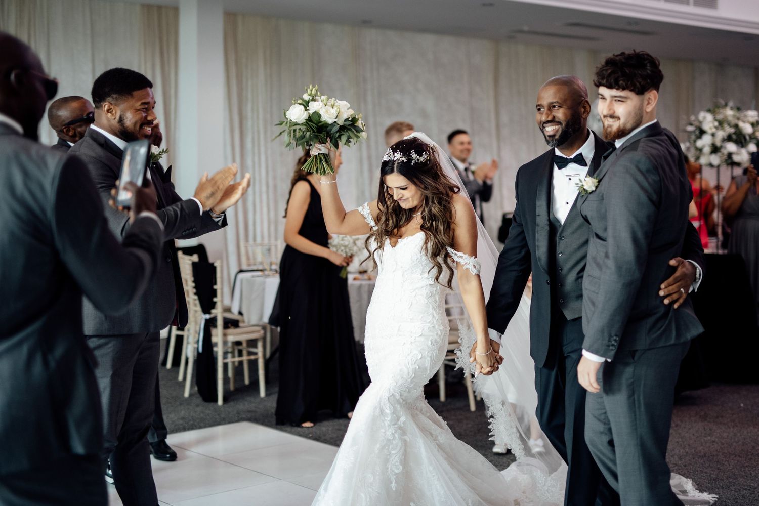 Wedding reception celebration with guests dancing and socializing.
