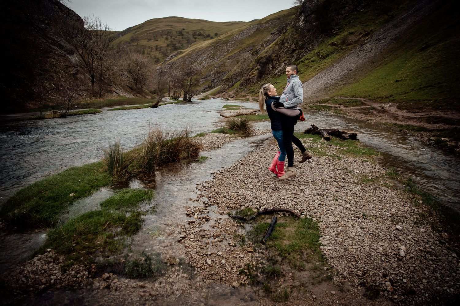 Hiking couple explores rocky mountain trail during outdoor adventure.