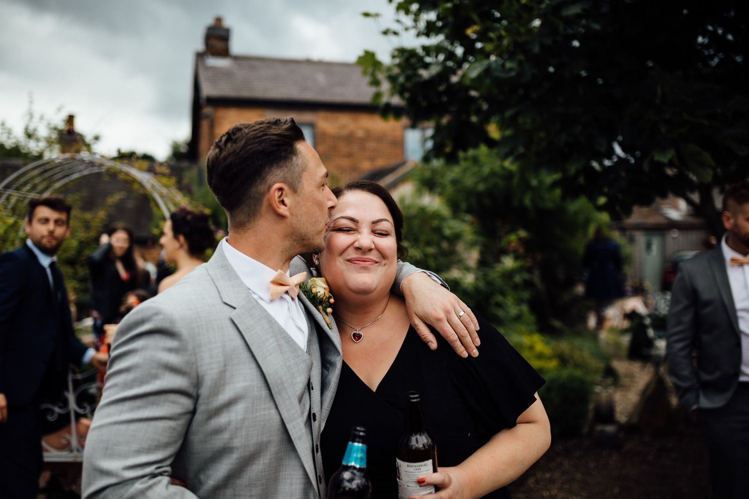 Candid moment of celebration at an outdoor wedding reception.