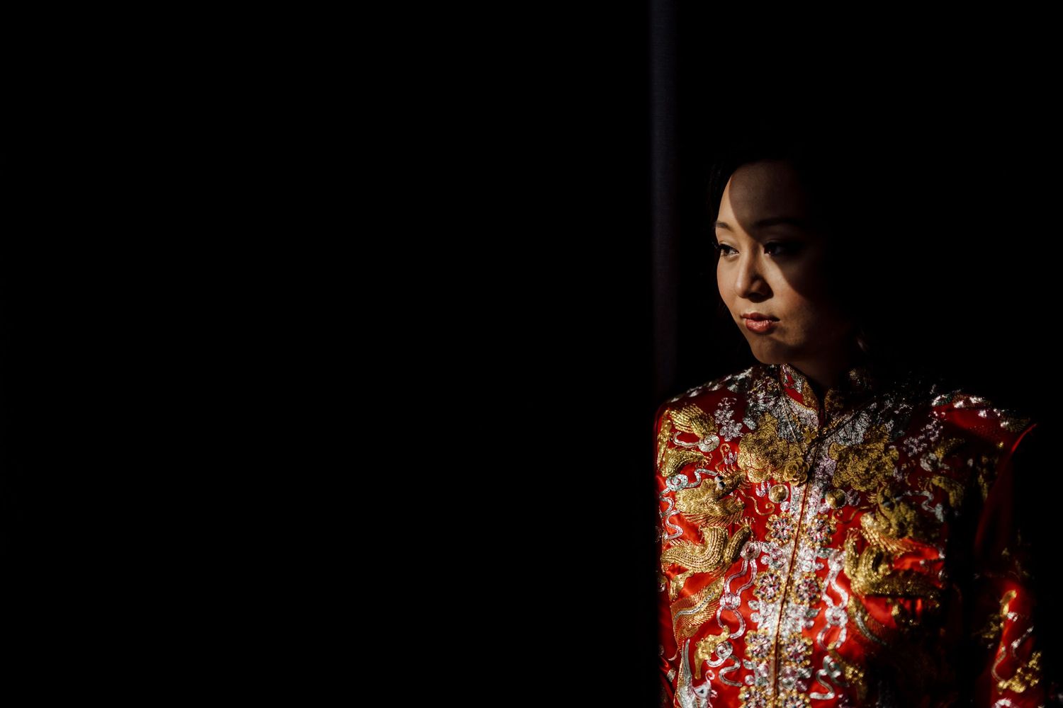 Traditional Chinese wedding dress details with intricate red and gold embroidery.