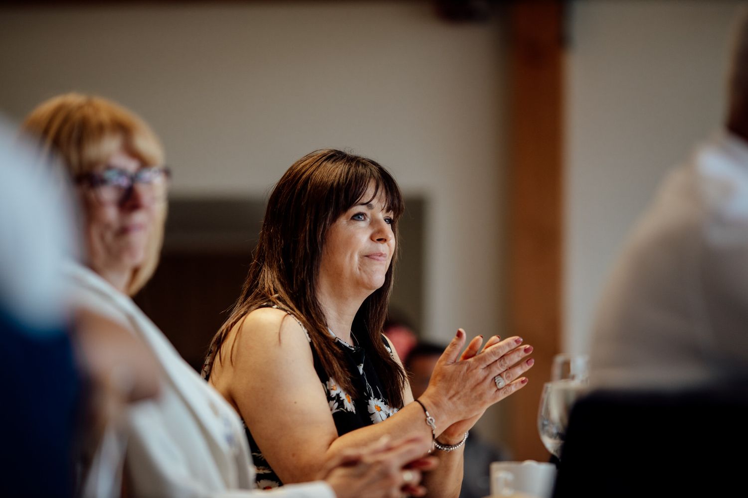 Wedding guests react emotionally during reception speeches and toasts.