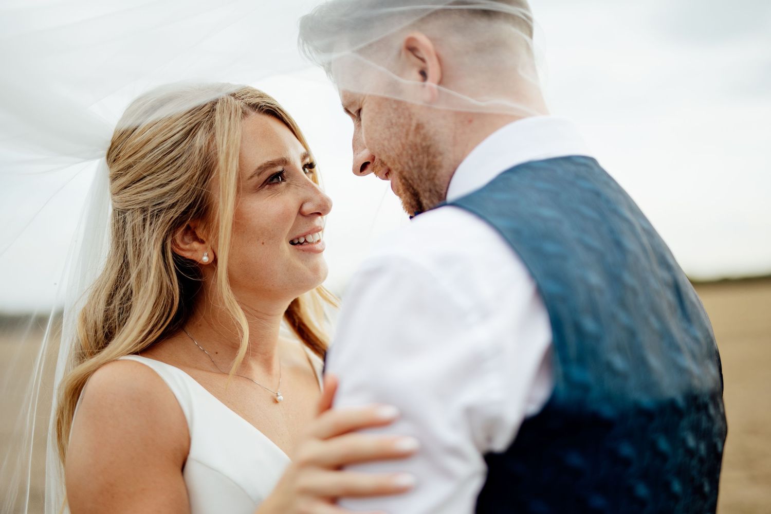 Romantic couple portrait session in a sunlit outdoor setting.