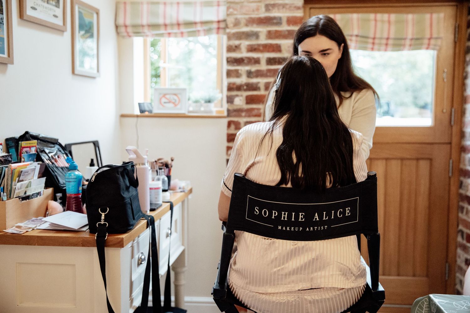Behind-the-scenes photography session in a rustic brick-walled room.