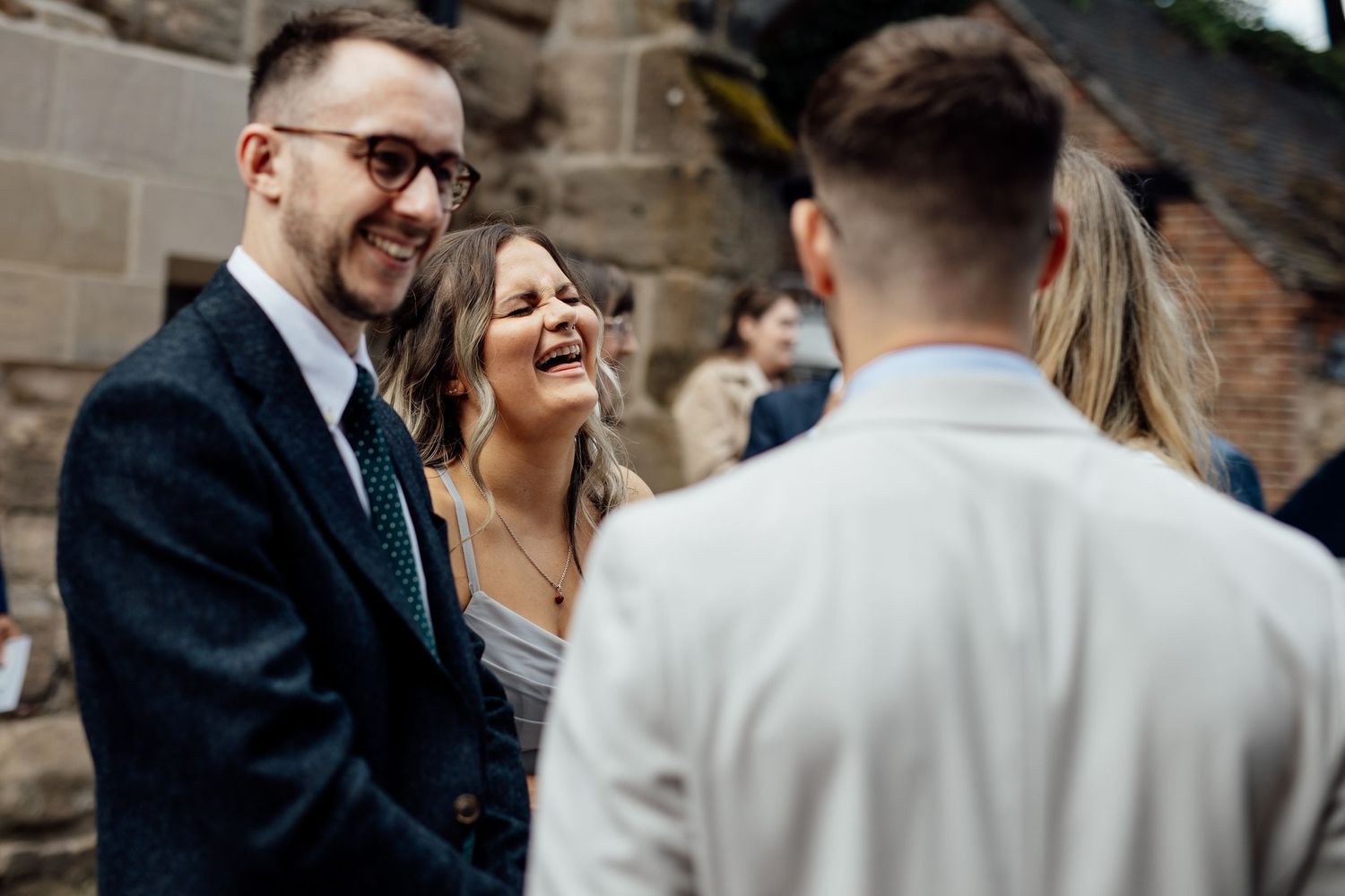 Wedding guests mingle and socialize during an outdoor celebration.