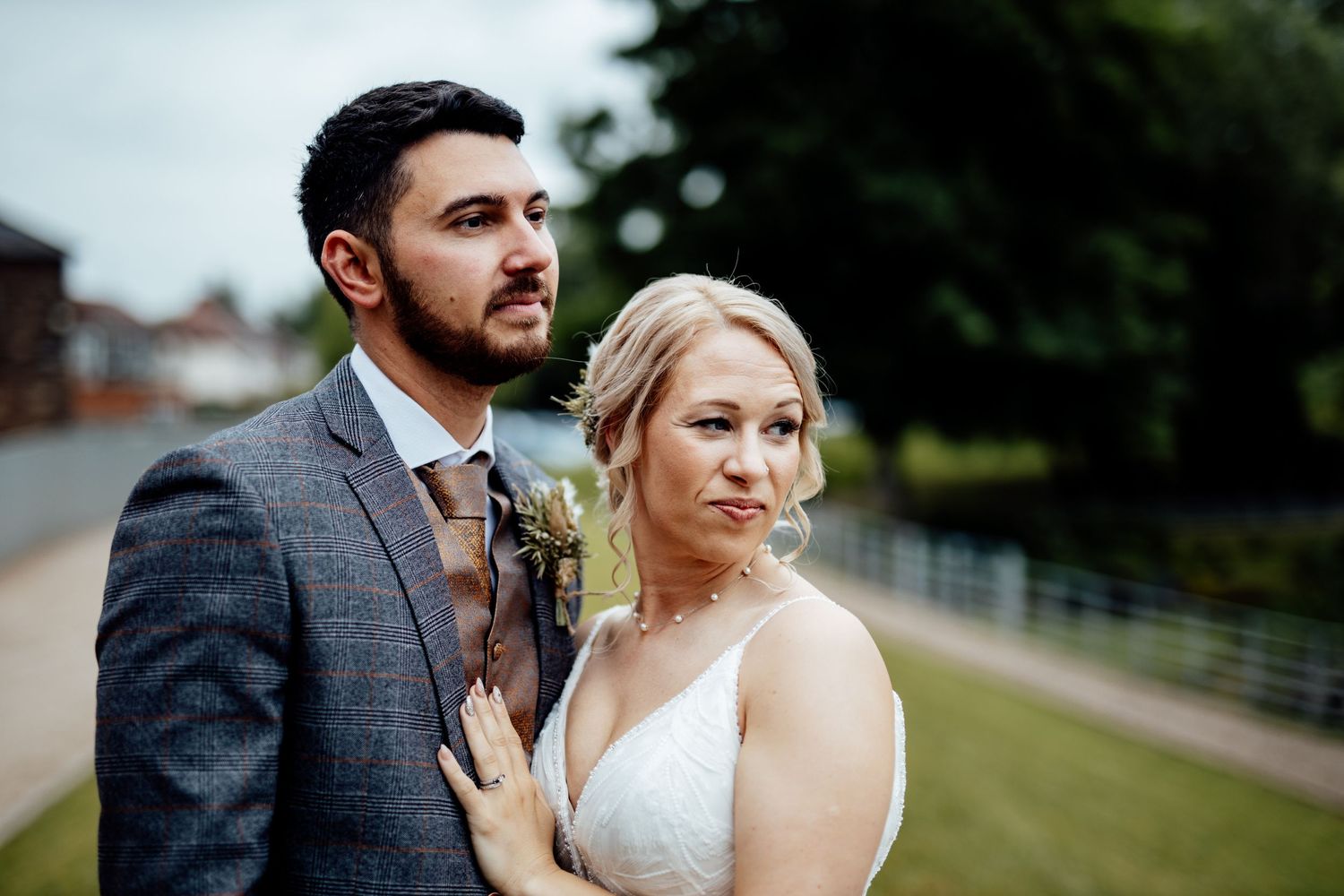Newlyweds posing outdoors for romantic portrait session.