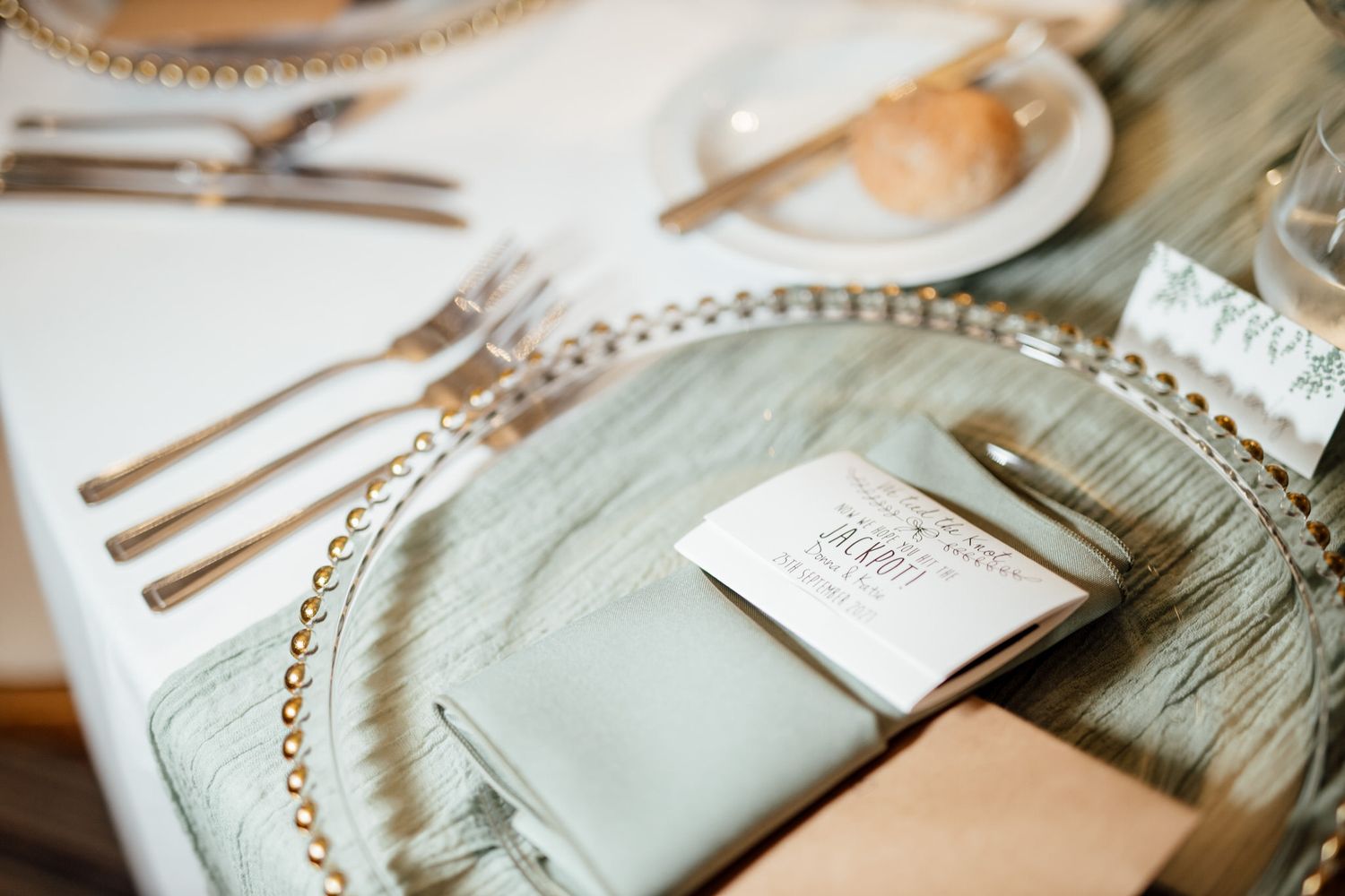 Wedding stationery and paper details laid out on a rustic wooden surface with elegant calligraphy.