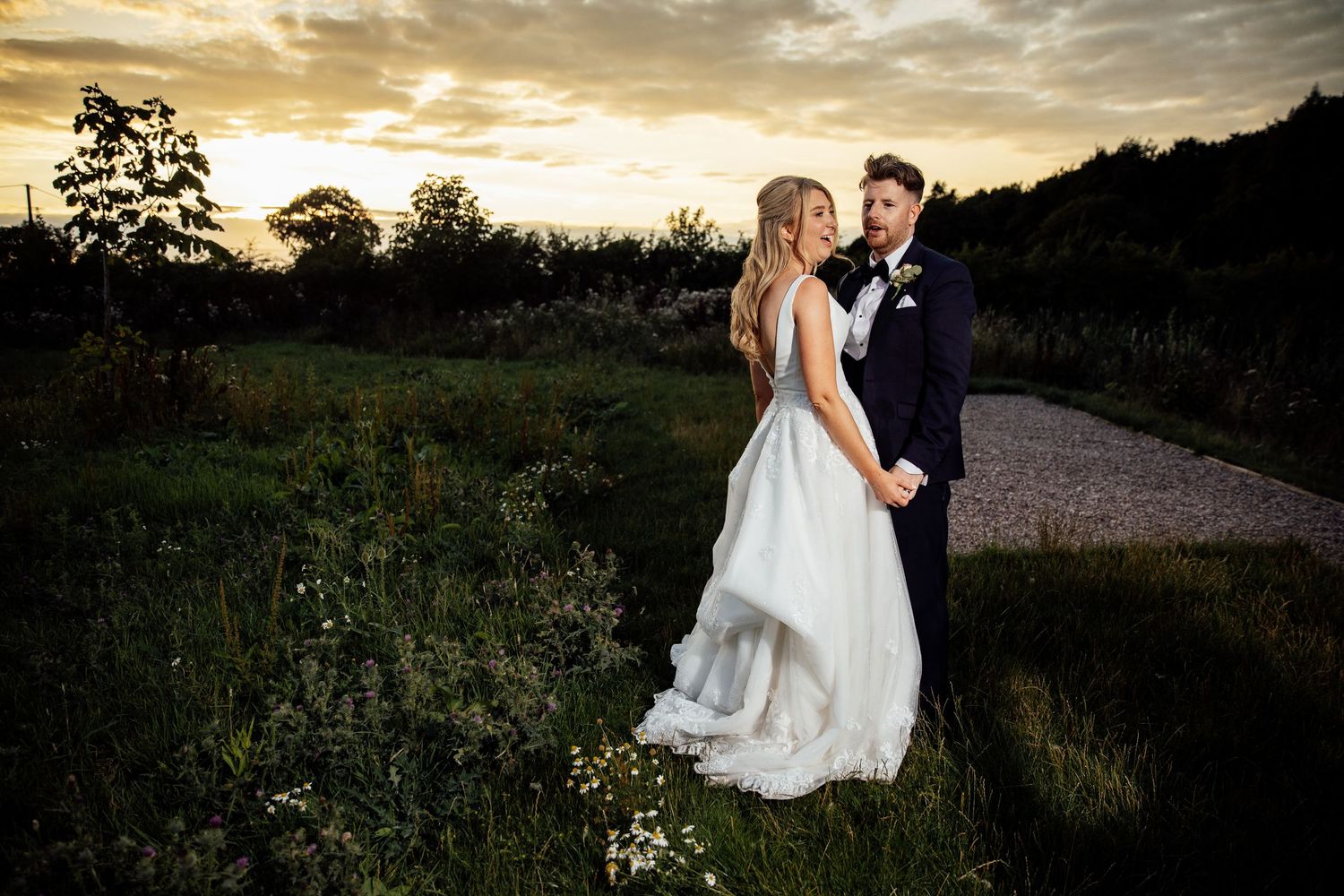 Romantic sunset portraits of newlyweds in a natural outdoor setting.