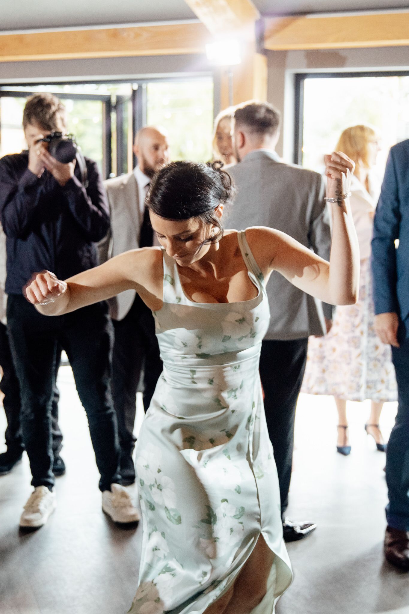 Wedding reception dance floor with guests enjoying lively celebration.