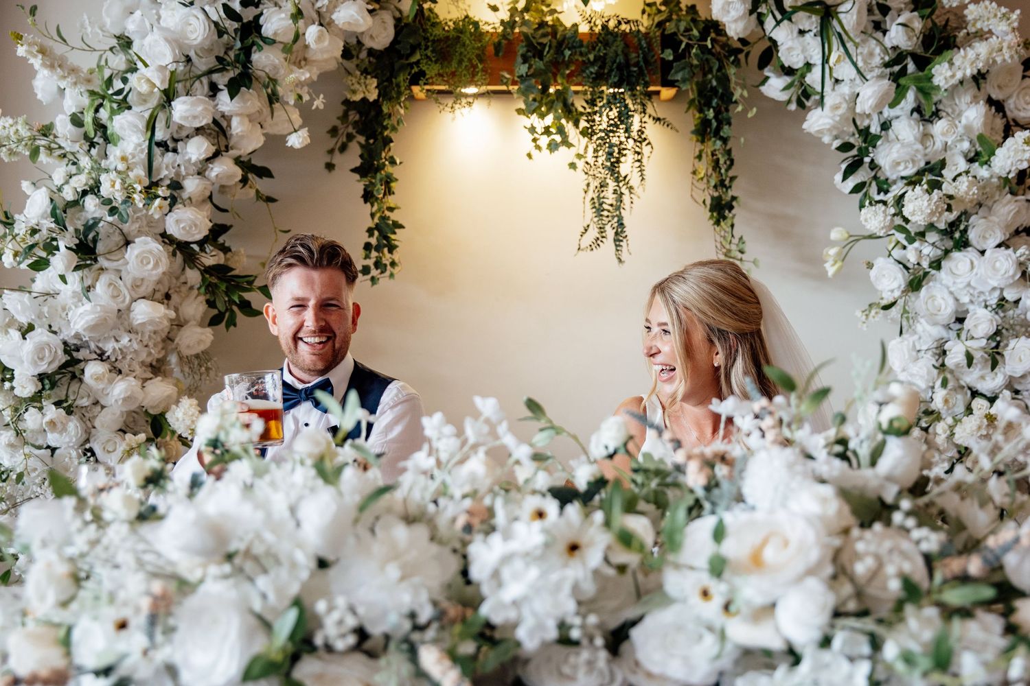 White floral wedding arch decorations create an elegant backdrop for a romantic ceremony.