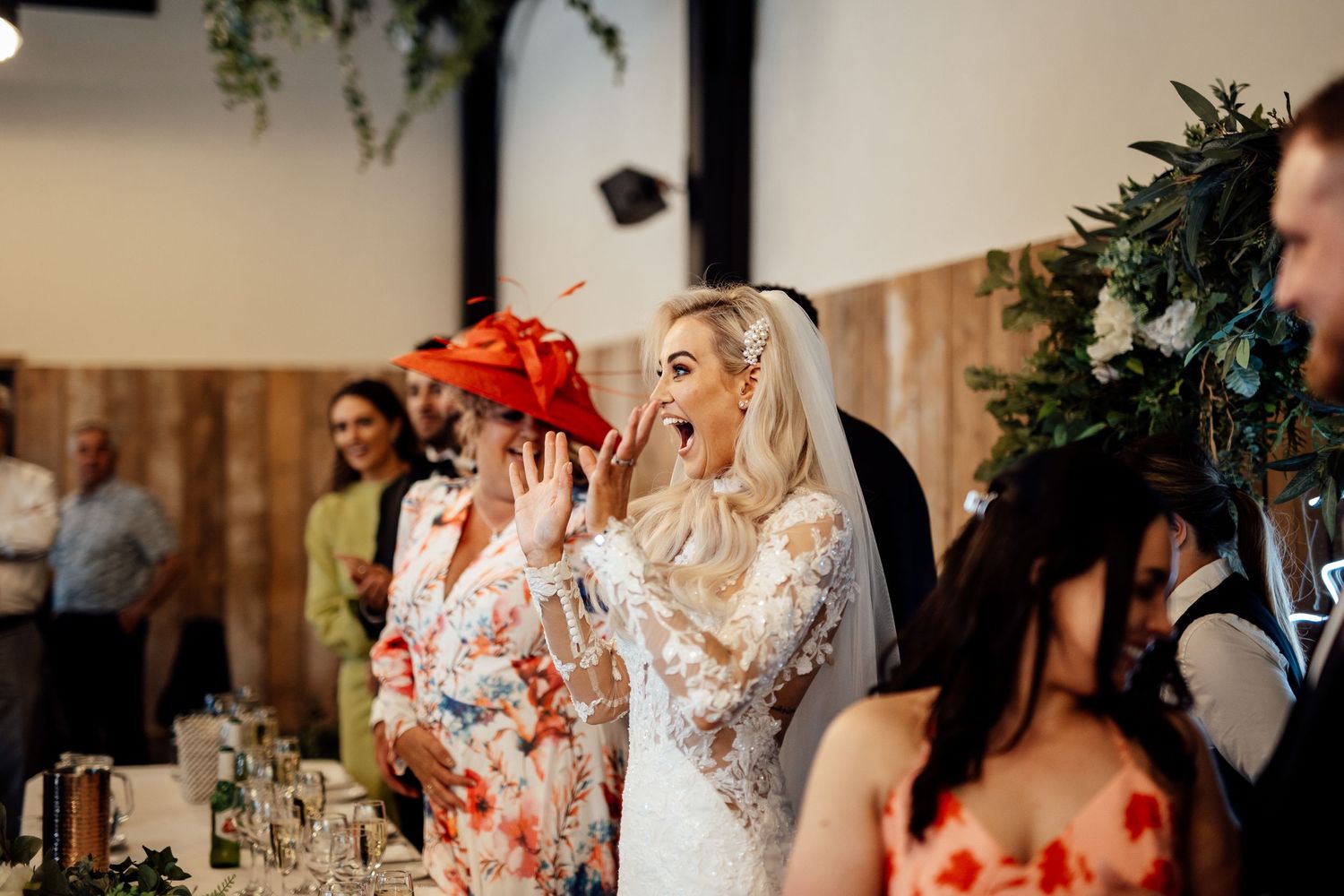Wedding reception venue decorated with romantic floral arrangements and soft lighting.