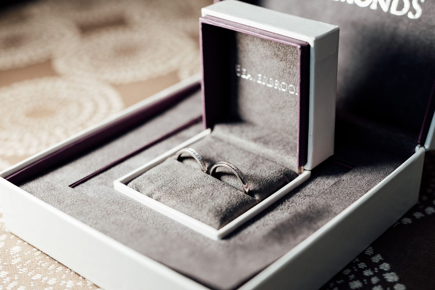 Close-up detail of wedding rings in elegant jewelry boxes.