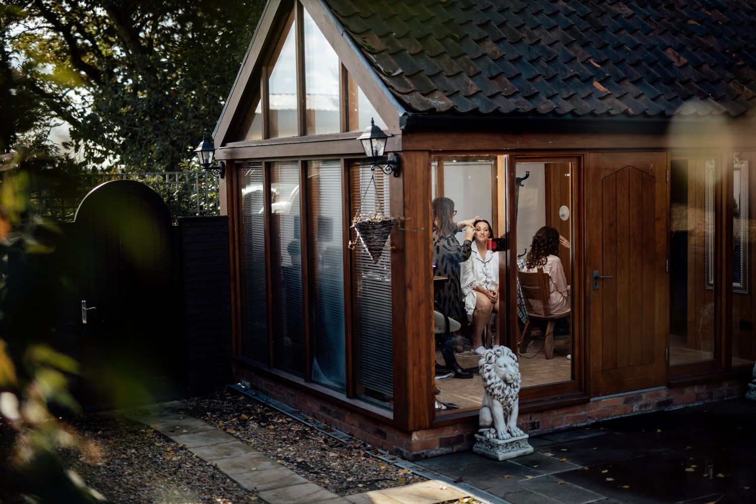 Rustic wooden venue exterior with Tudor-style architecture and landscaped grounds.