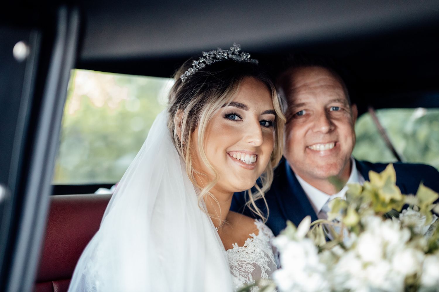 Wedding couple sharing joyful moment together in car.