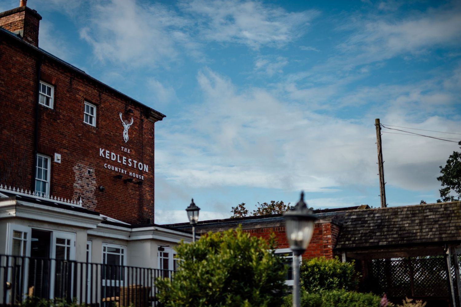 Row of traditional red brick buildings under bright blue sky.