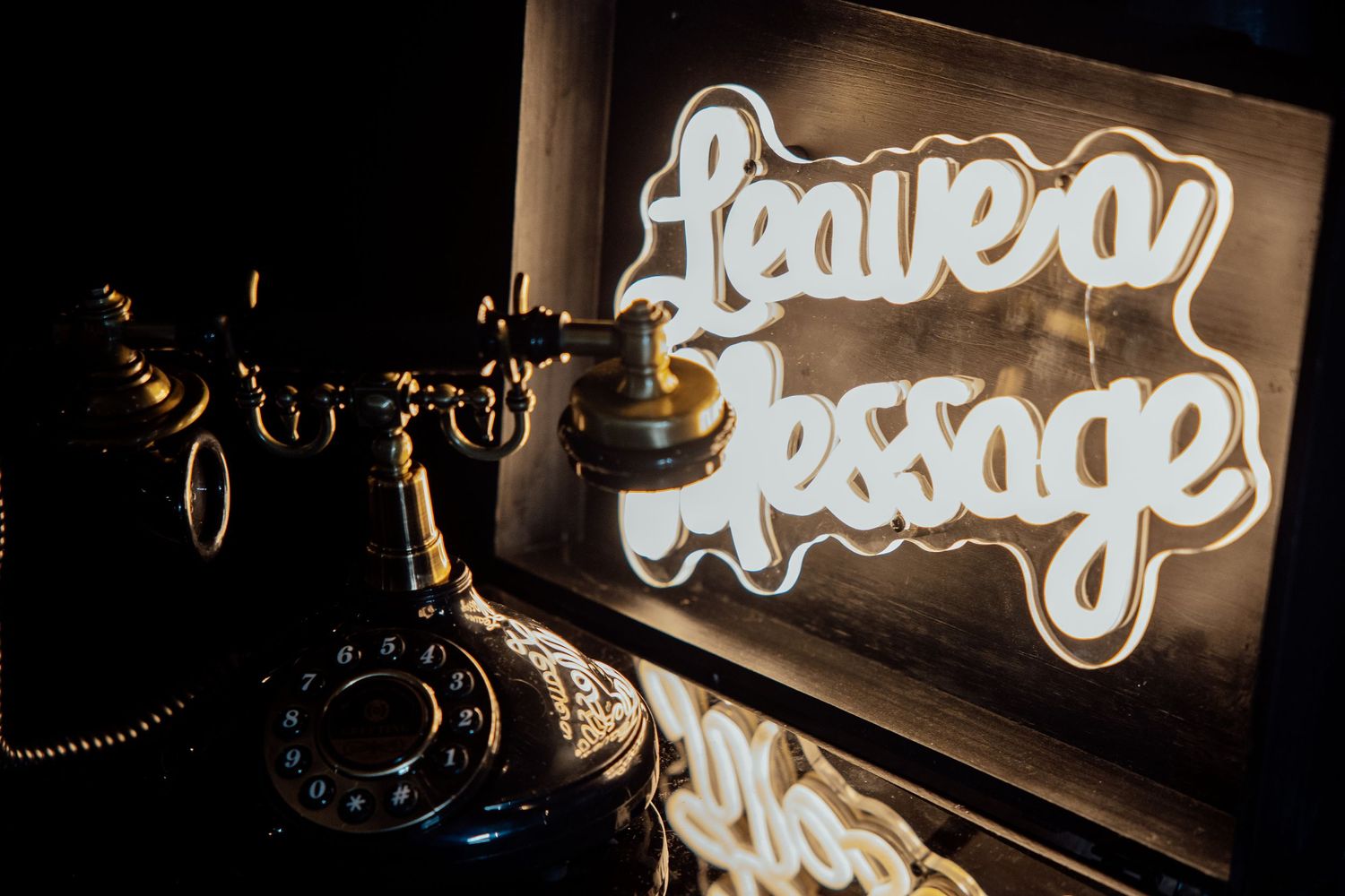 Illuminated neon signs and decorative elements create a warm ambiance in a dimly lit bar or restaurant setting.