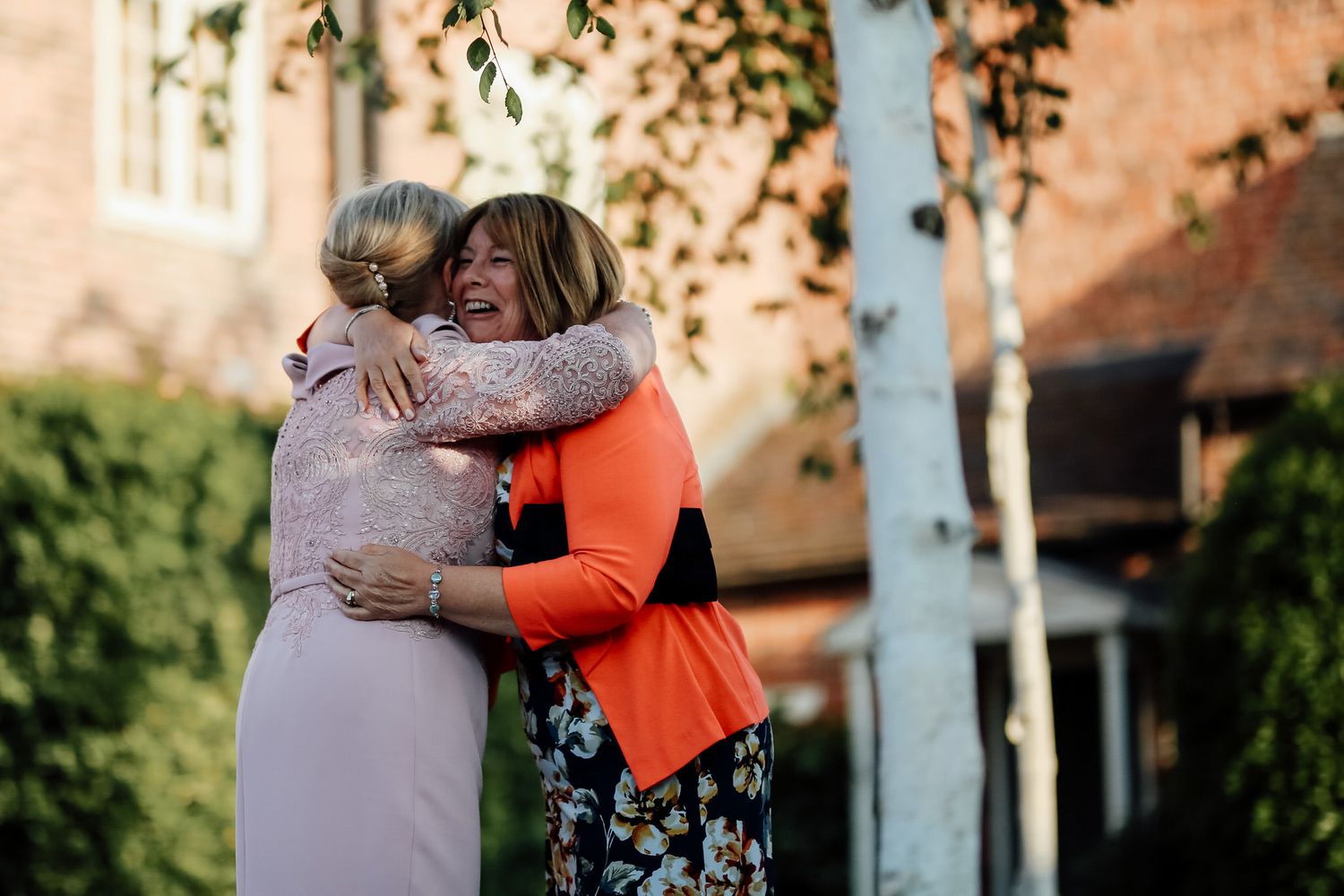 wedding guests hugging