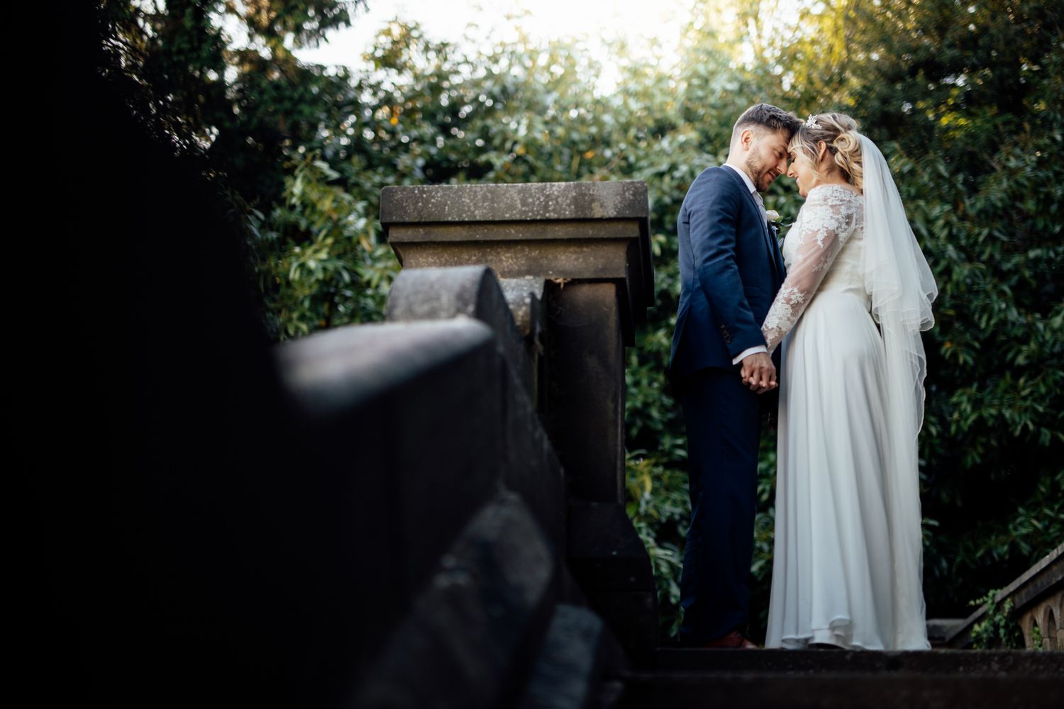 Romantic outdoor garden wedding ceremony under natural lighting.