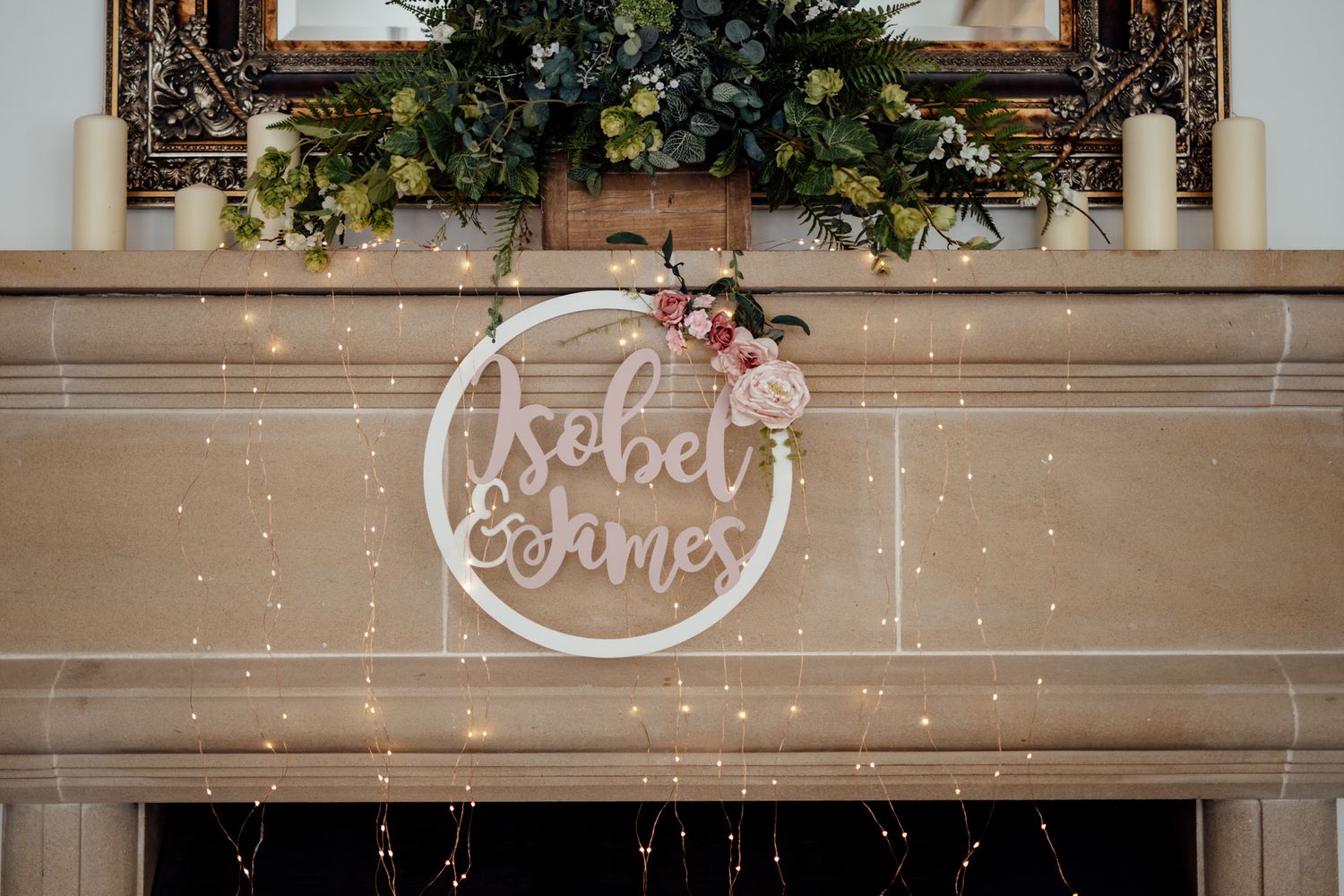 Decorative wooden wedding signage with names displayed on rustic beams.