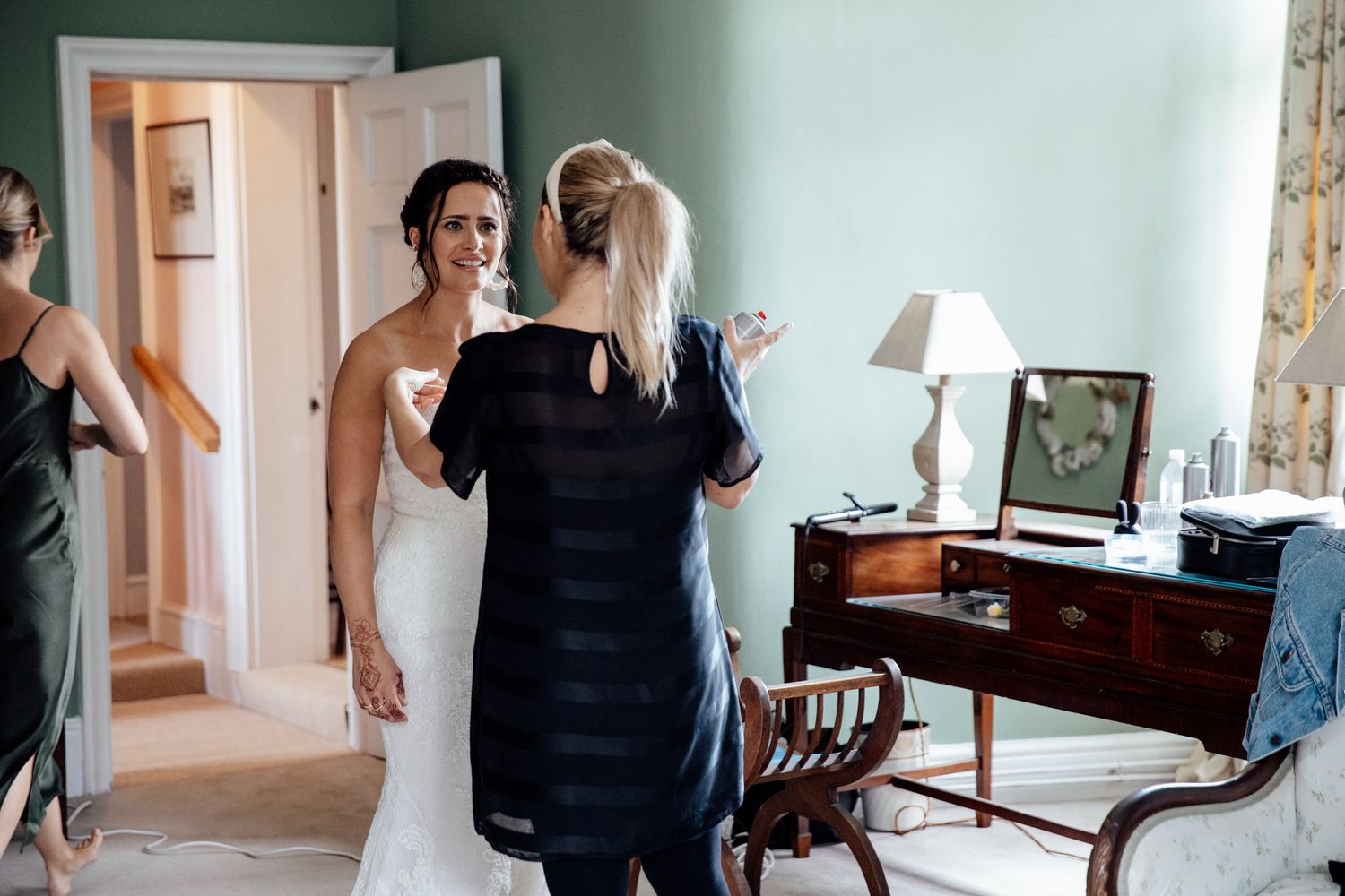 Wedding party preparations in an elegant room with natural lighting.