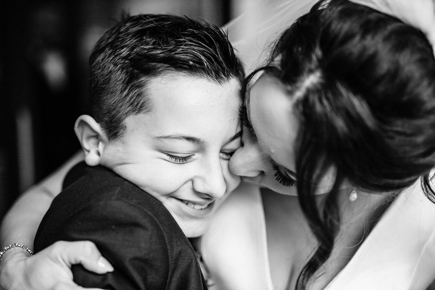 Close-up black and white wedding moments showing emotional expressions and intimate interactions.