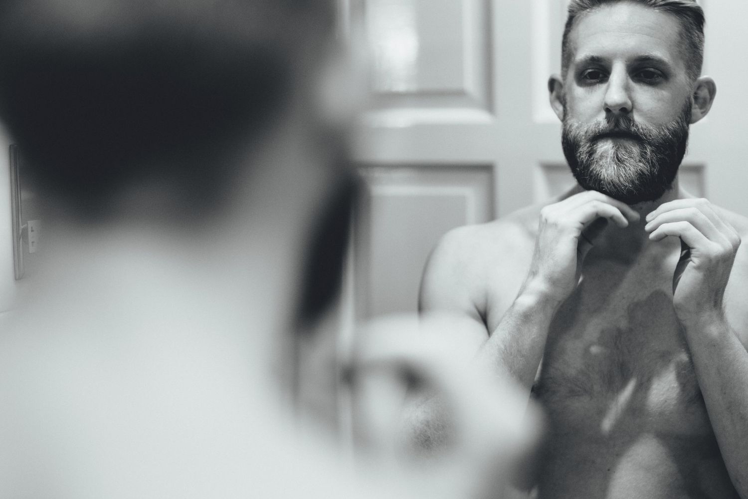 Black and white portrait of men getting ready for formal event.