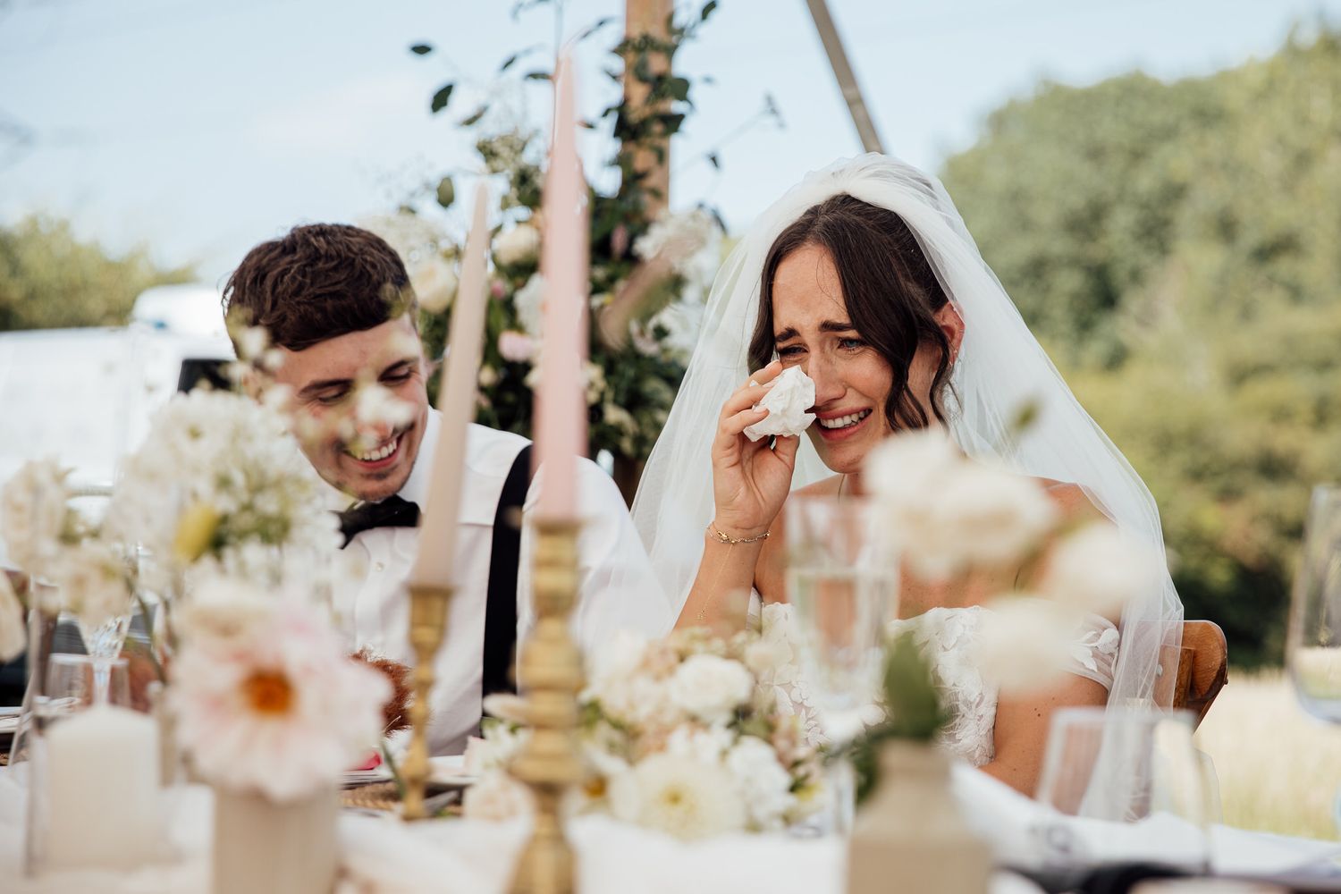 Candid wedding reception moments captured with natural light and floral decorations.