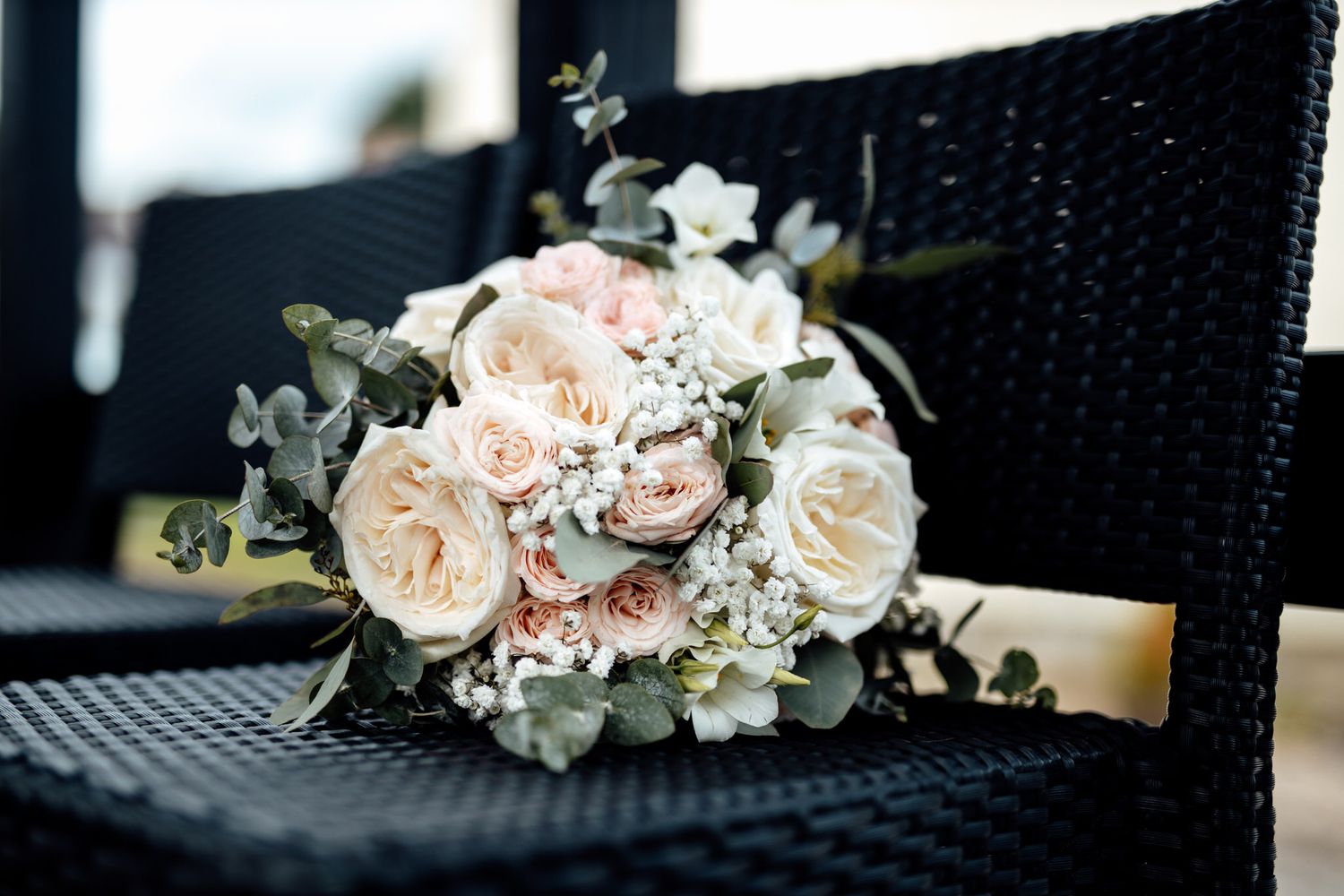 Elegant floral arrangements with pale pink roses and eucalyptus leaves.