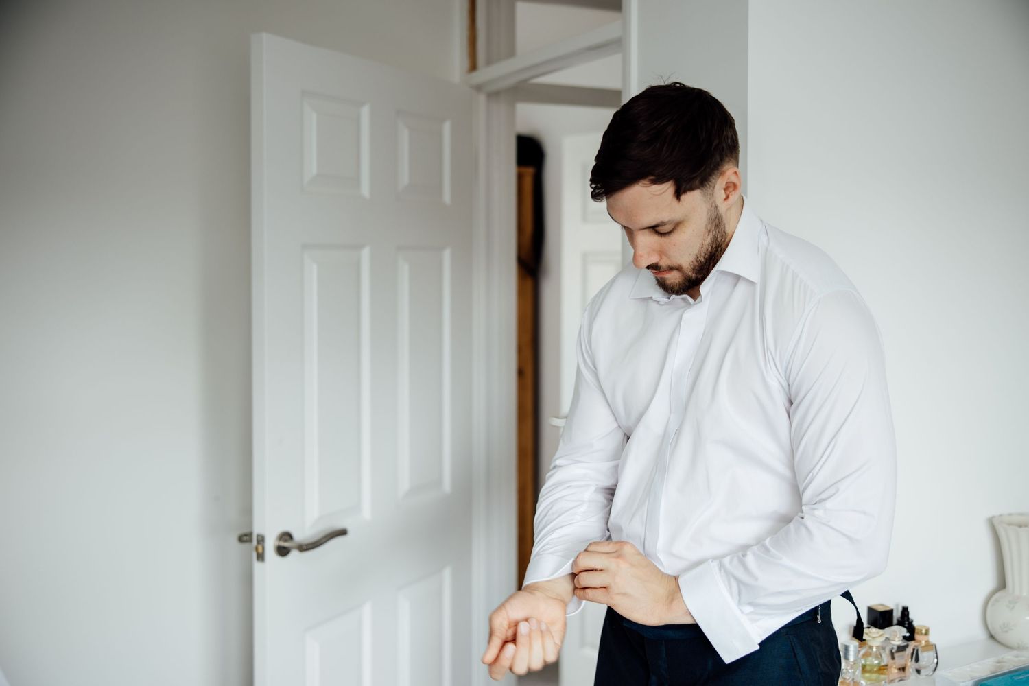 A series of getting ready photos showing wedding day preparations in a bright white room.