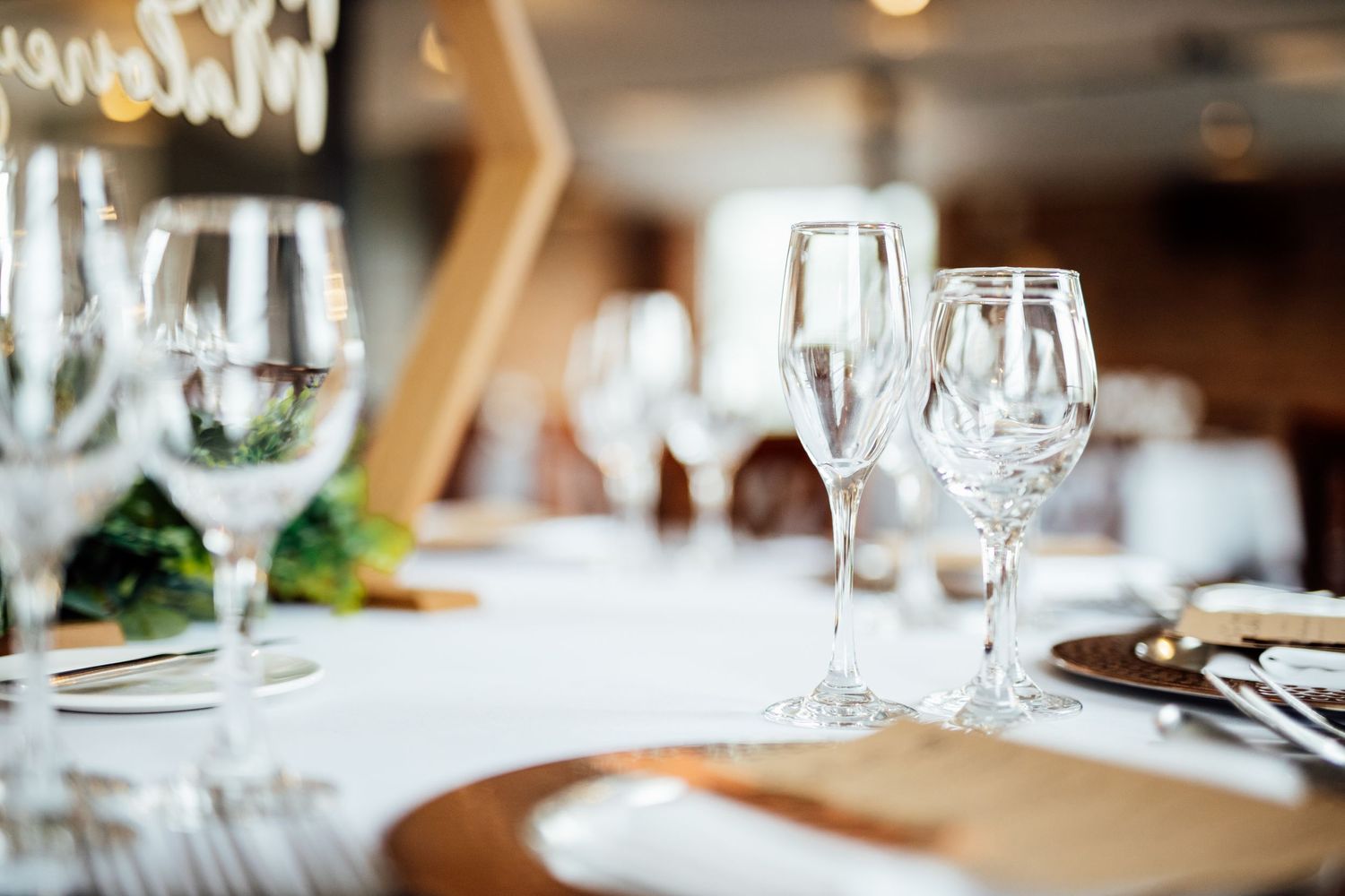 Elegant table setting with wine glasses and place settings at a formal event.