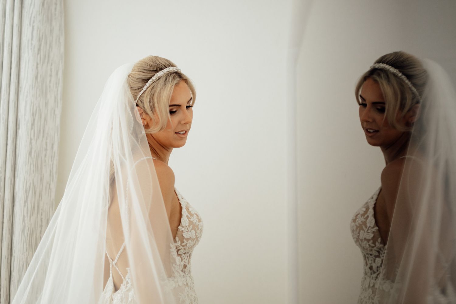 Elegant bridal veil preparation sequence showing delicate lace details in soft natural lighting.