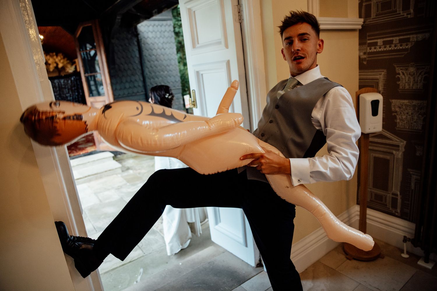 A playful dance move with someone being dipped dramatically in an elegant indoor setting.